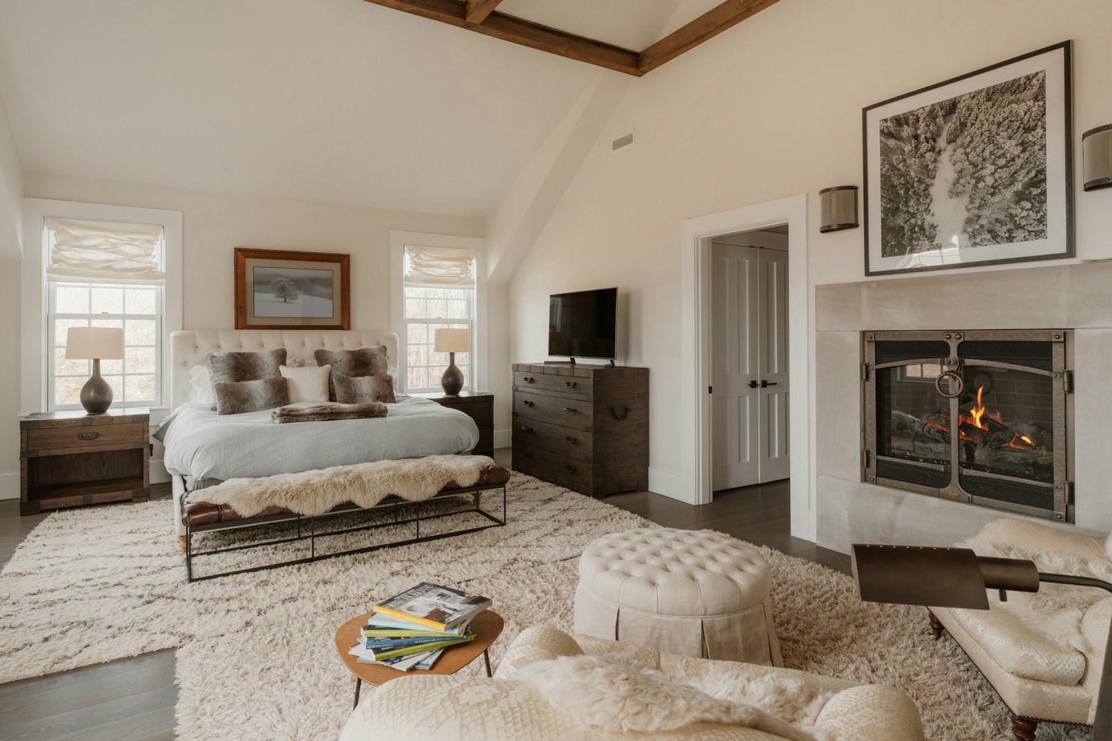 Spacious bedroom with a fireplace and large bed