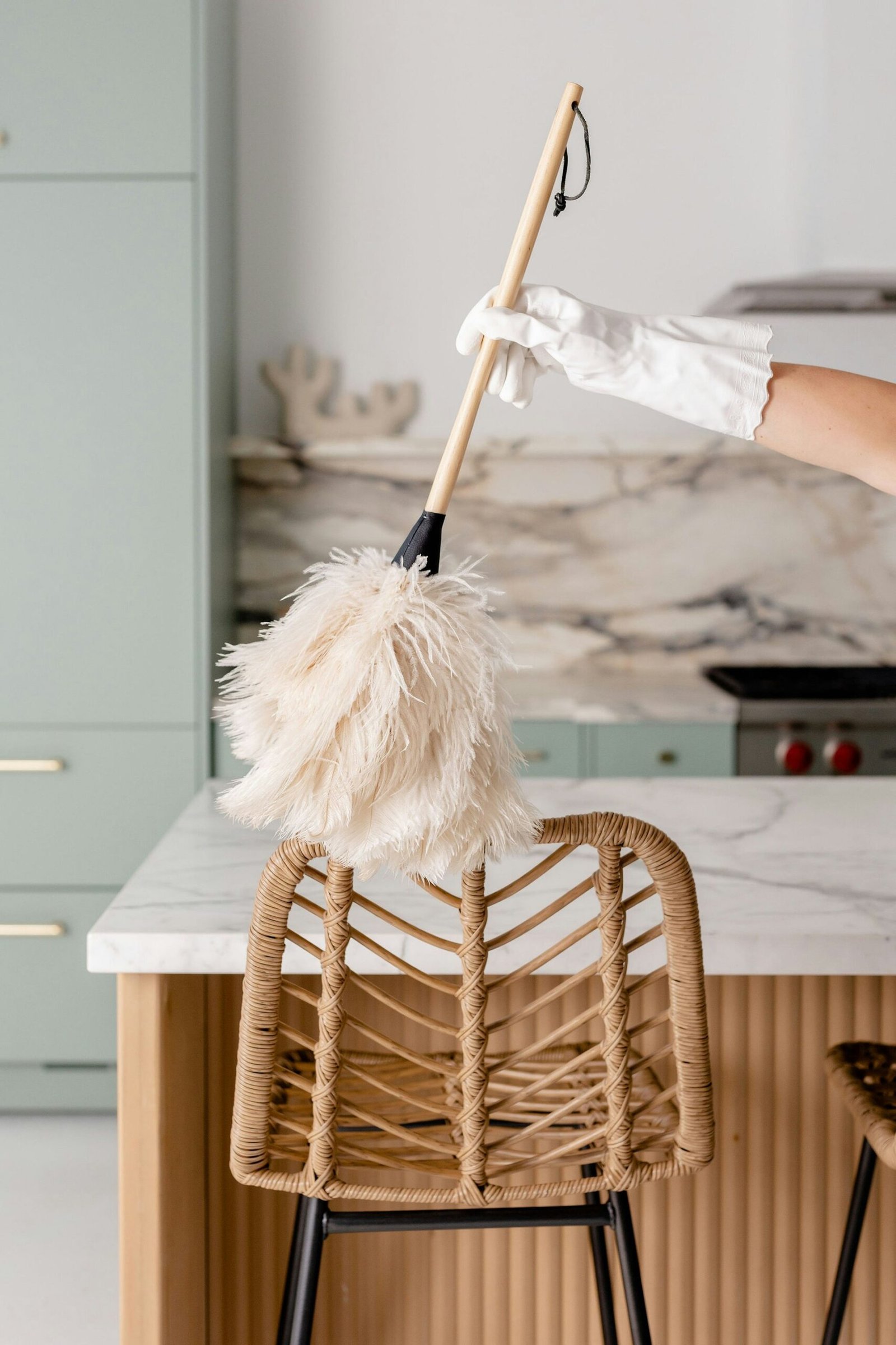 a person in white gloves is cleaning a chair