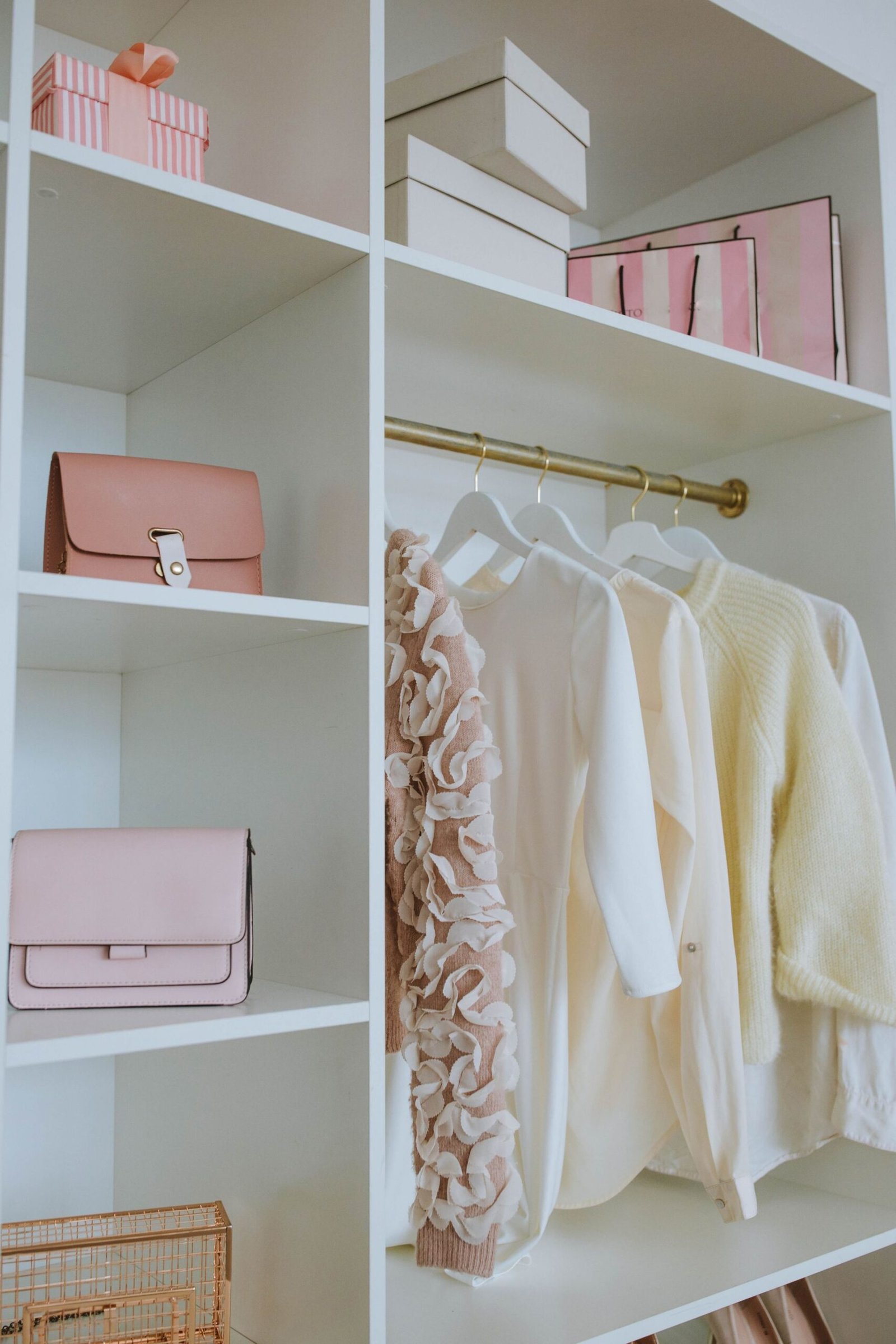 Stylish feminine wardrobe with clothes, bags, and gifts neatly or