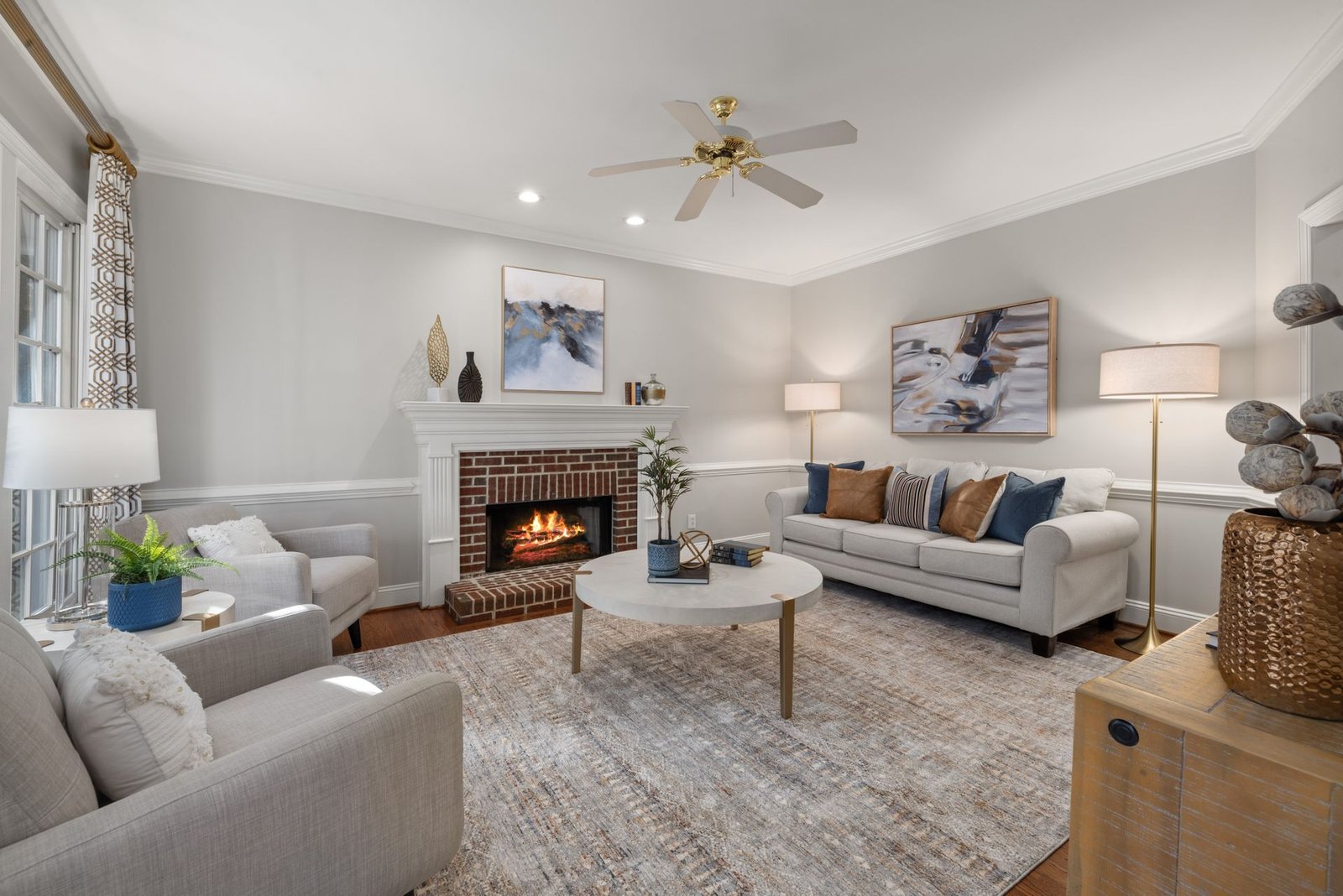 A cozy modern living room featuring a fireplace, elegant sofa, an