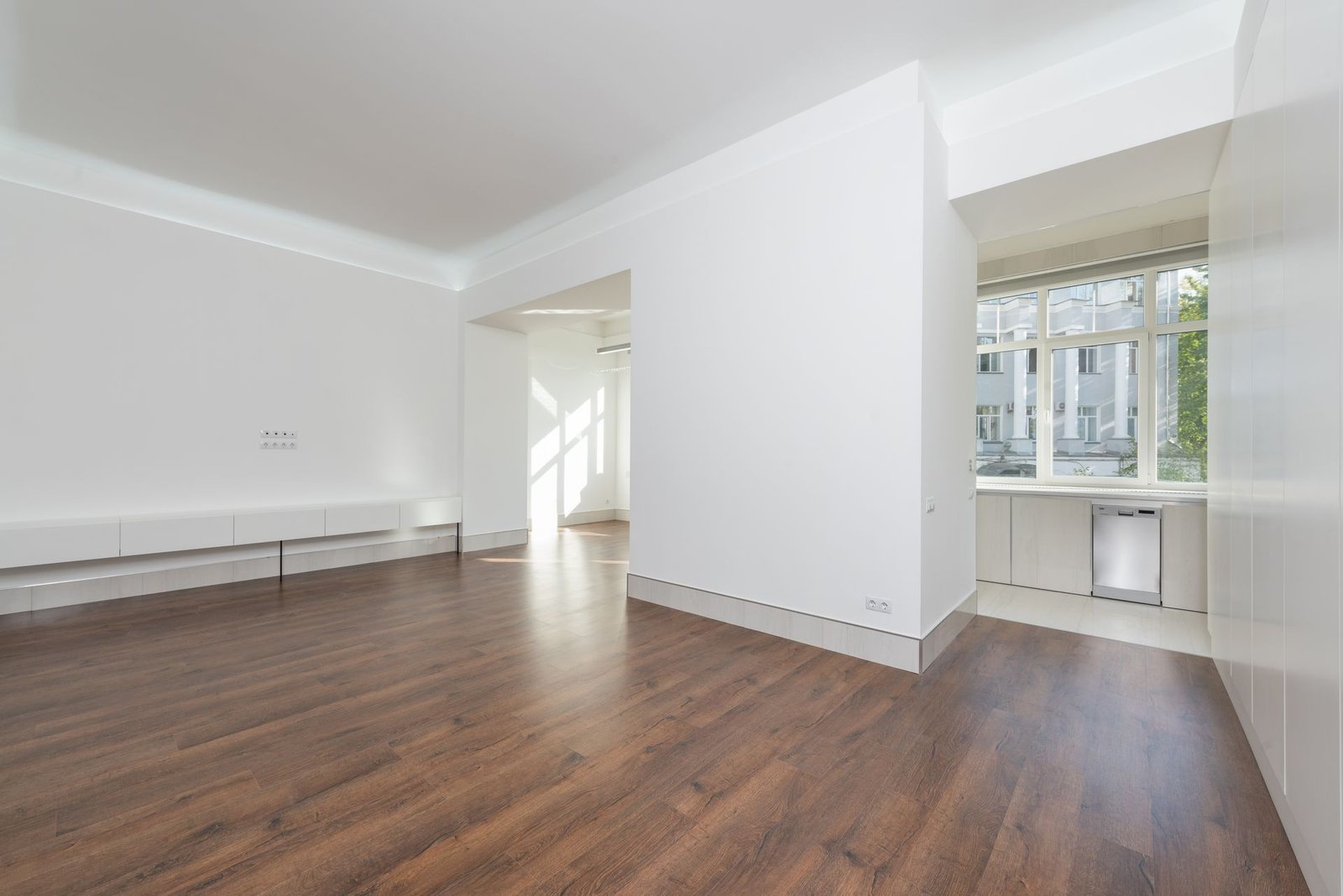 A contemporary empty apartment with white walls and wooden floori