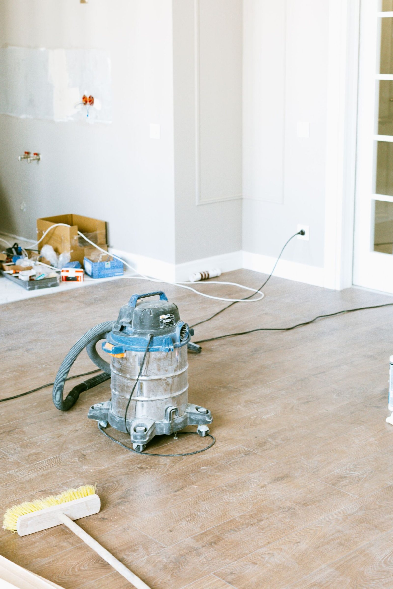 Vacuum and tools in a room undergoing renovation, showcasing home